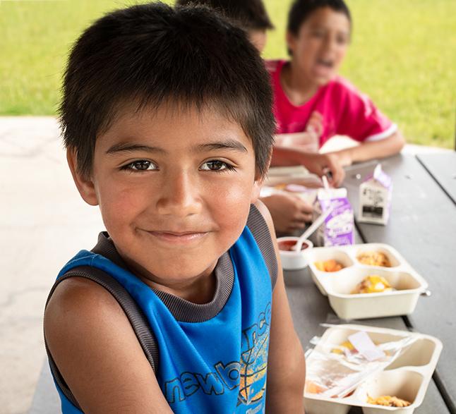 Child sitting at picnic table