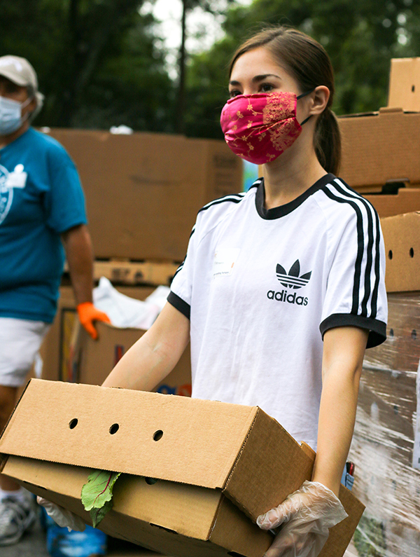 Volunteer with mask at food distribution
