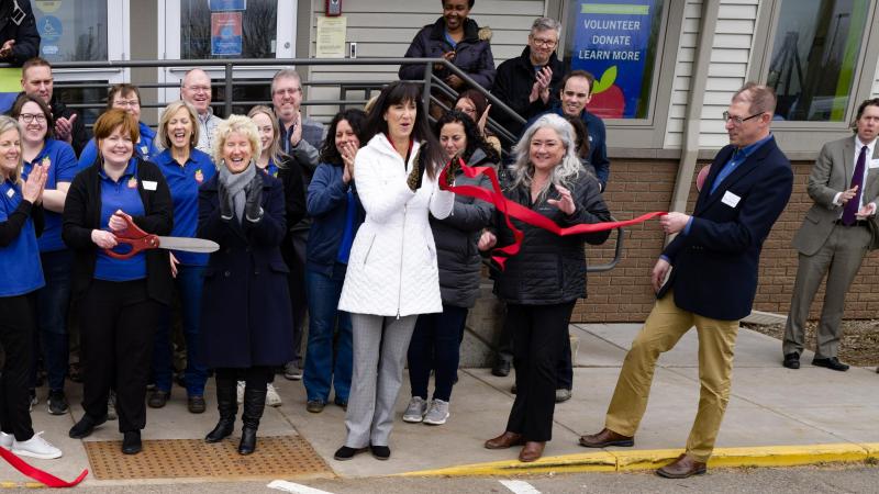 A group of people clap after ribbon cutting ceremony