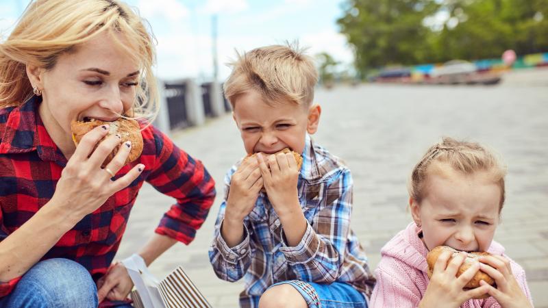 mom and kids eating burgers mom and kids eating burgers