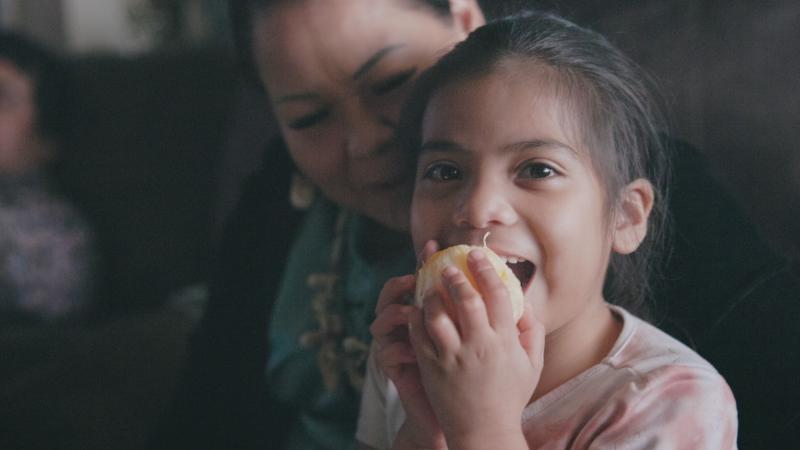 Girl eating orange
