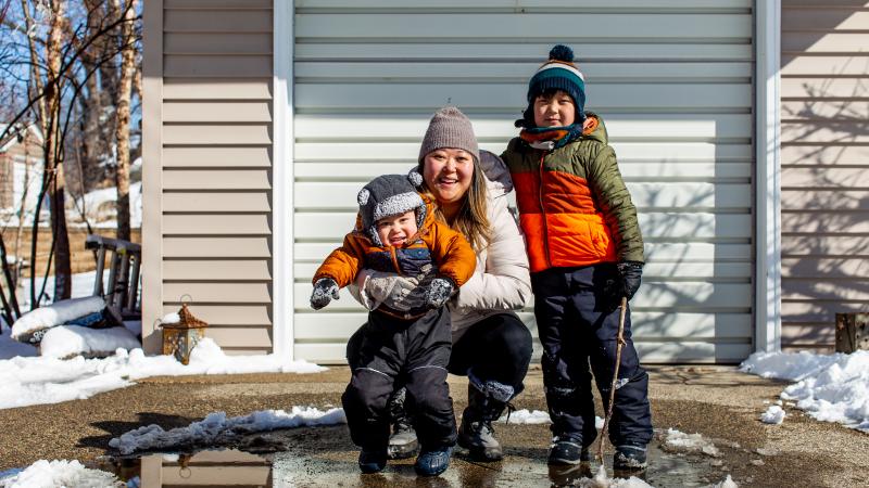 Mom and two sons in winter clothes outside