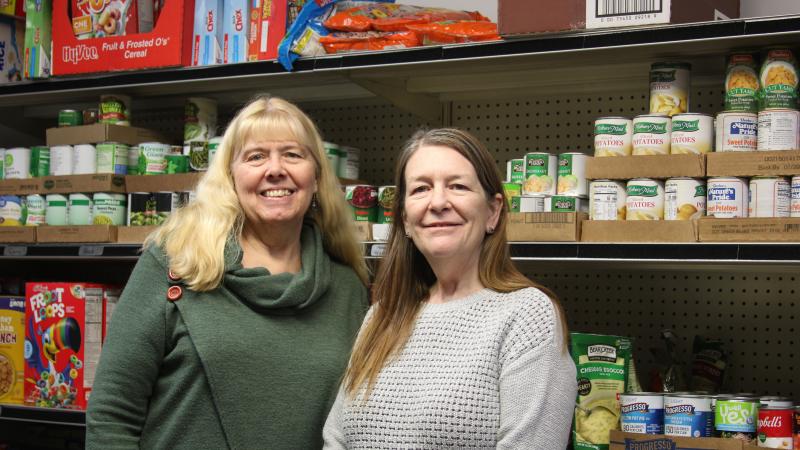 Two employees at a food pantry.
