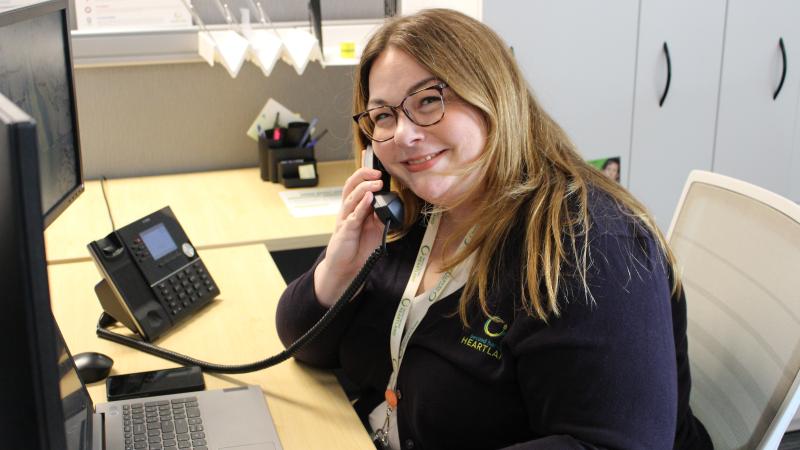 SNAP specialist on a telephone in an office