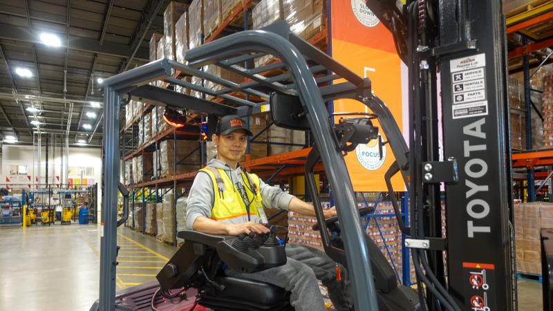 An order fulfiller operating a forklift