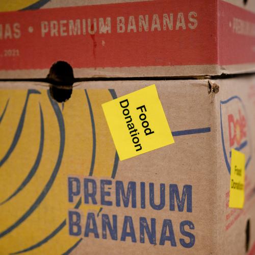 A box with a picture of bananas on it with a "food donation" sticker