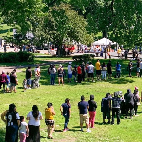 Line in park at food distribution