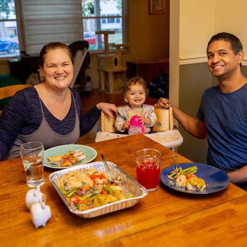 family sitting at table enjoying a meal