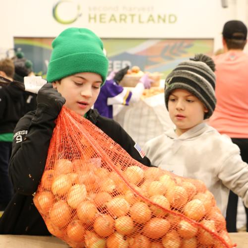 Two kids pack potatoes