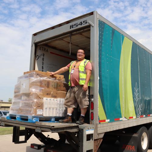 Second Harvest Heartland Delivery Driver smiling on the truck