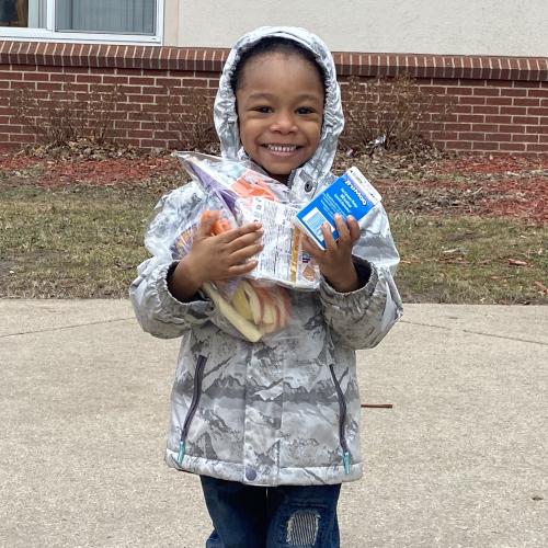 Child holding on to school lunch food