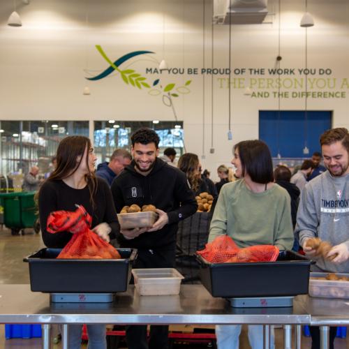 Volunteers pack potatoes during a volunteer shift