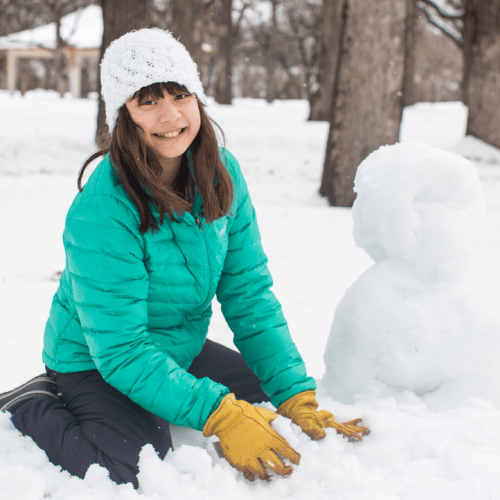 Girl building snowman