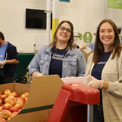 Two volunteers packing food