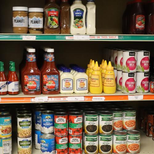 A shelf with condiments and groceries