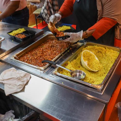 A worker plates rice and beans