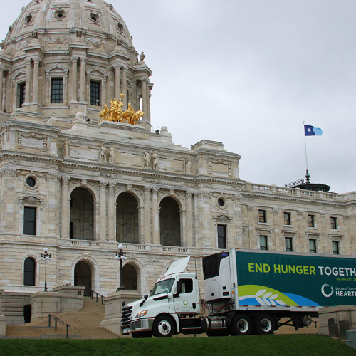 A Second Harvest Heartland semi truck in front of the Minnesota State Capitol building