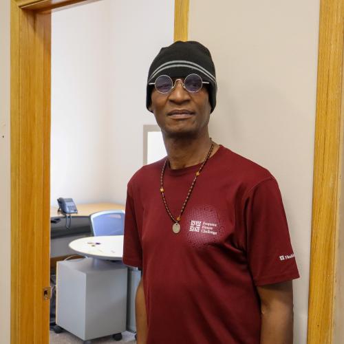A portrait of a man in a red shirt