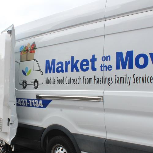A white van with "Market on the Move" on the side