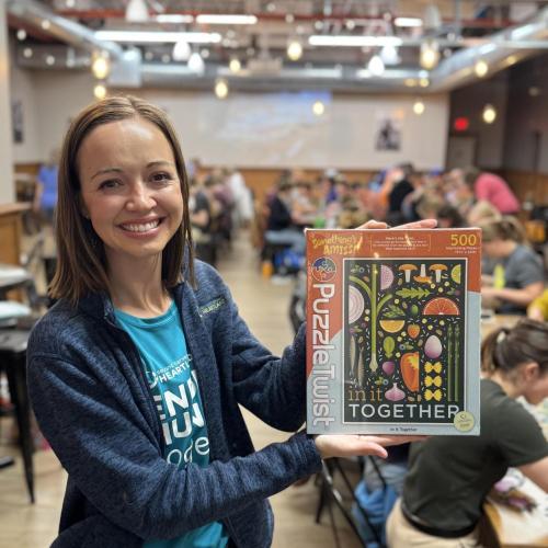 Woman holding up puzzle box
