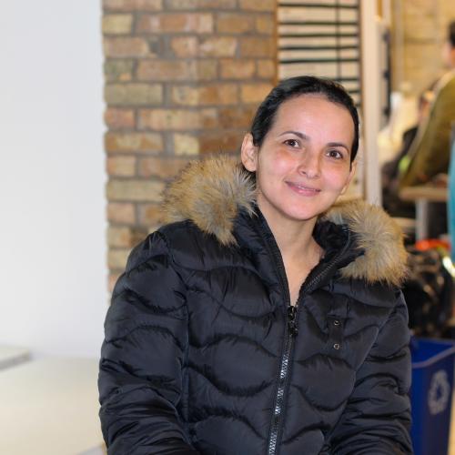 A woman in a coat at a food shelf