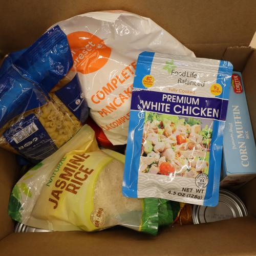 Box filled with food like pasta, rice and chicken