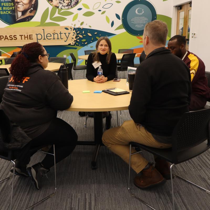 Partners exchange ideas around a conference table