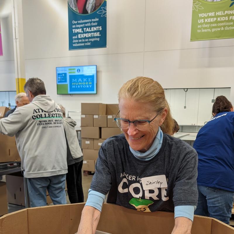 Shirley sorting apples at a volunteer shift