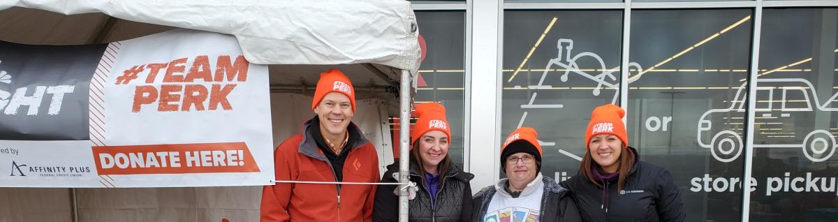 A group of people stand outside grocery store
