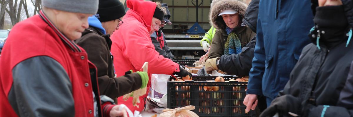 People getting food at a produce distribution event