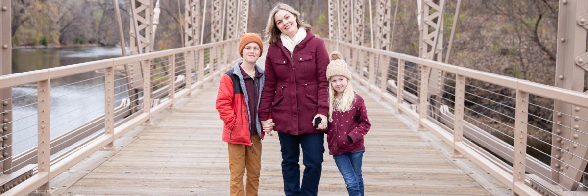 Mother and her two children standing on a bridge