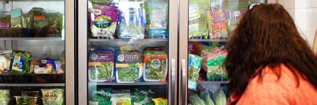 Person at Food Shelf Refrigerator
