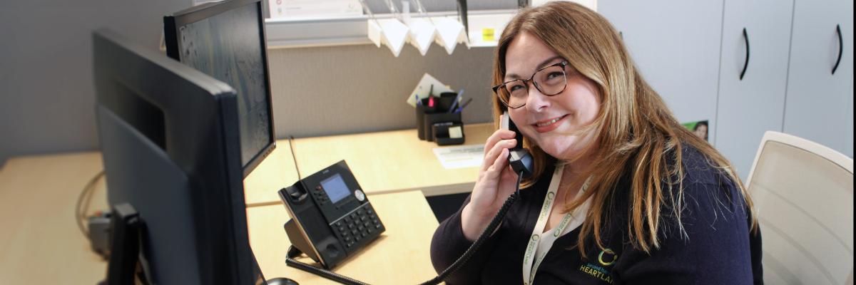 Woman answering a phone at the Care Center