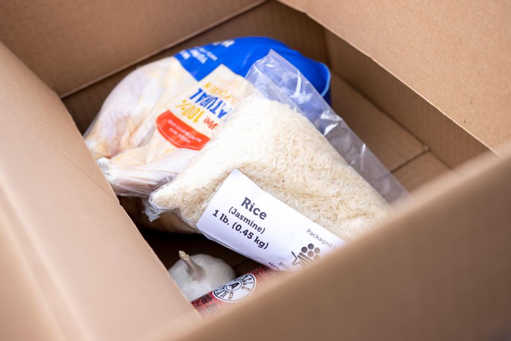Box containing a bag of jasmine rice and other food