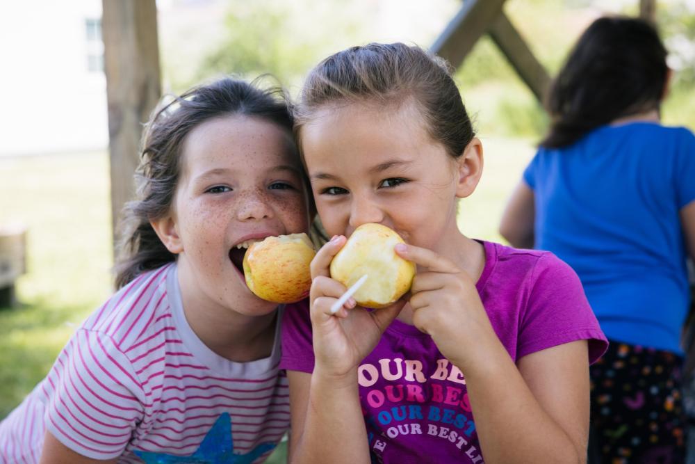 Two children eating apples