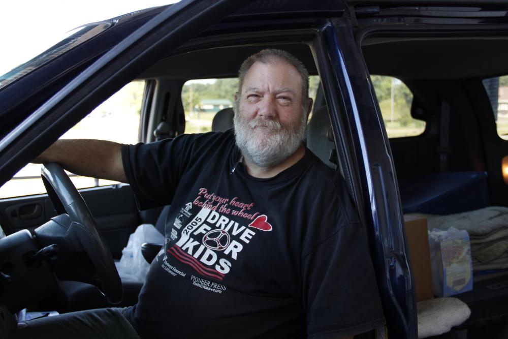 A man visits a drive through food distribution