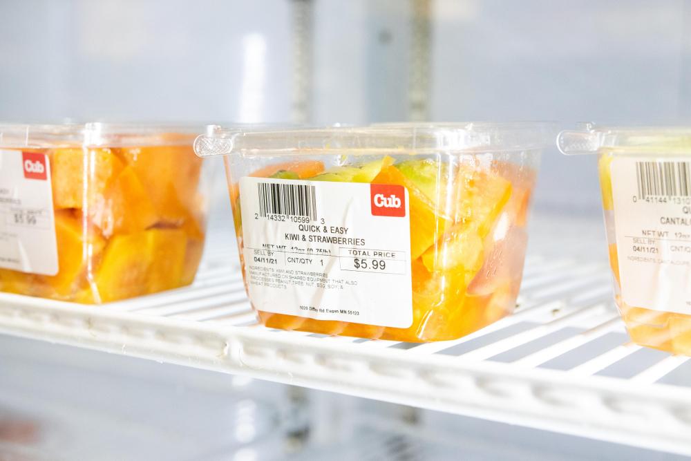 kiwi and strawberries in a plastic container