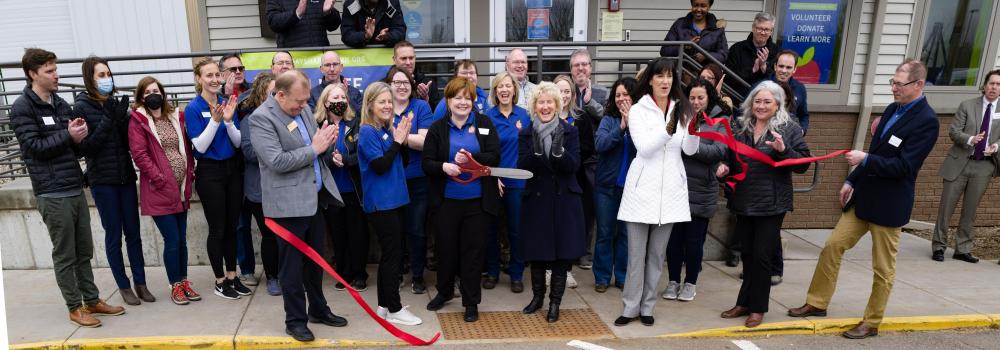 A group of people clap after ribbon cutting ceremony