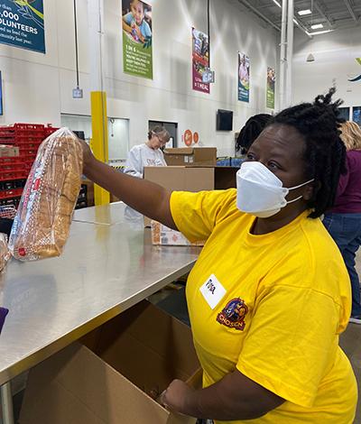 Volunteer packing bread