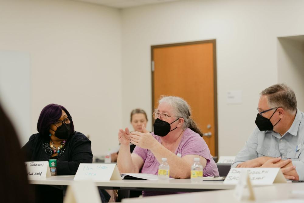 Elaine Walker, representative from SACA Food Shelf, discusses the importance of delivery programs with her colleague Dave Rudolph and Theresa Johnson from Shiloh Cares Food Shelf at the listening session in Minneapolis.