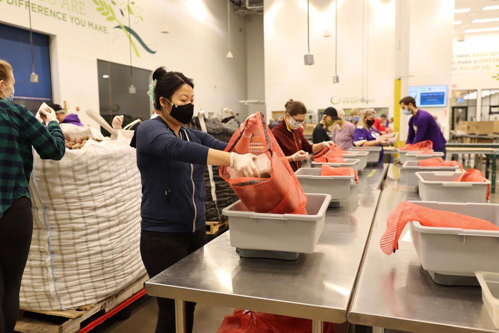 Volunteers repack potatoes in Volunteer Center