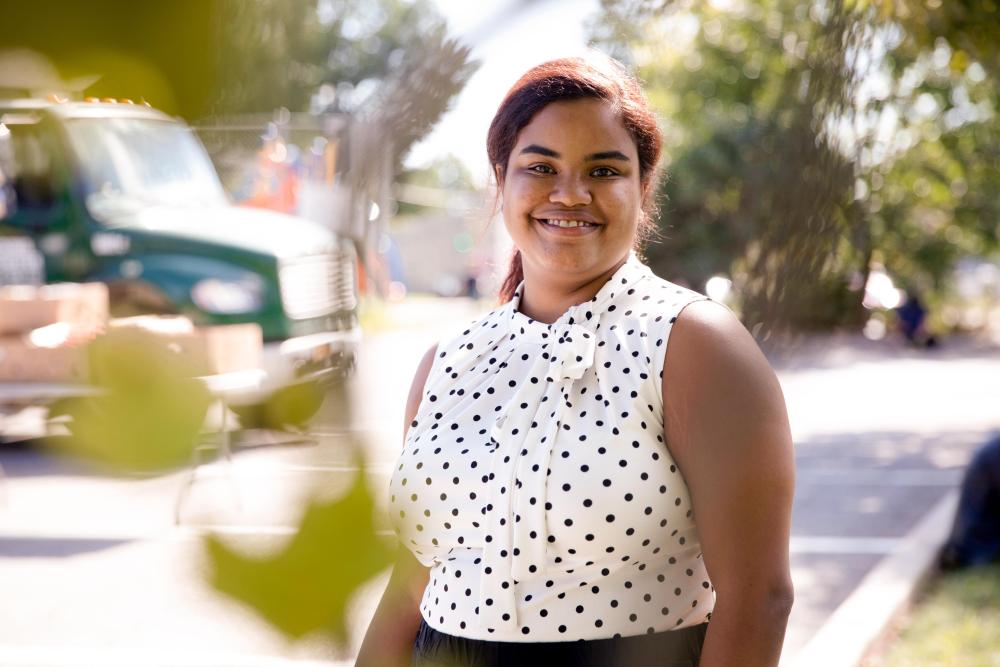 A food bank staff member smiles at the camera