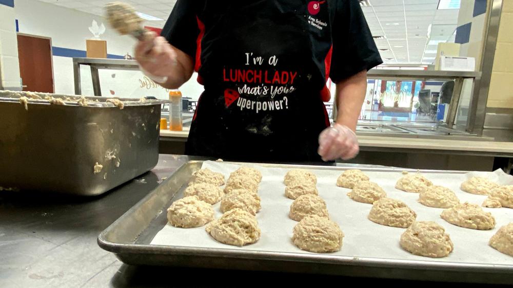 Lunch lady preparing food at school