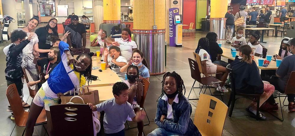 Kids smiling and sitting around tables at Pham's Rice Bowl
