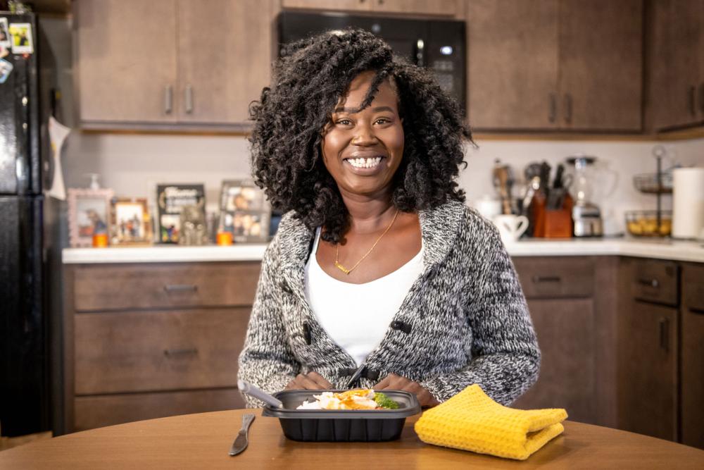 Nansi with a prepared meal in her home