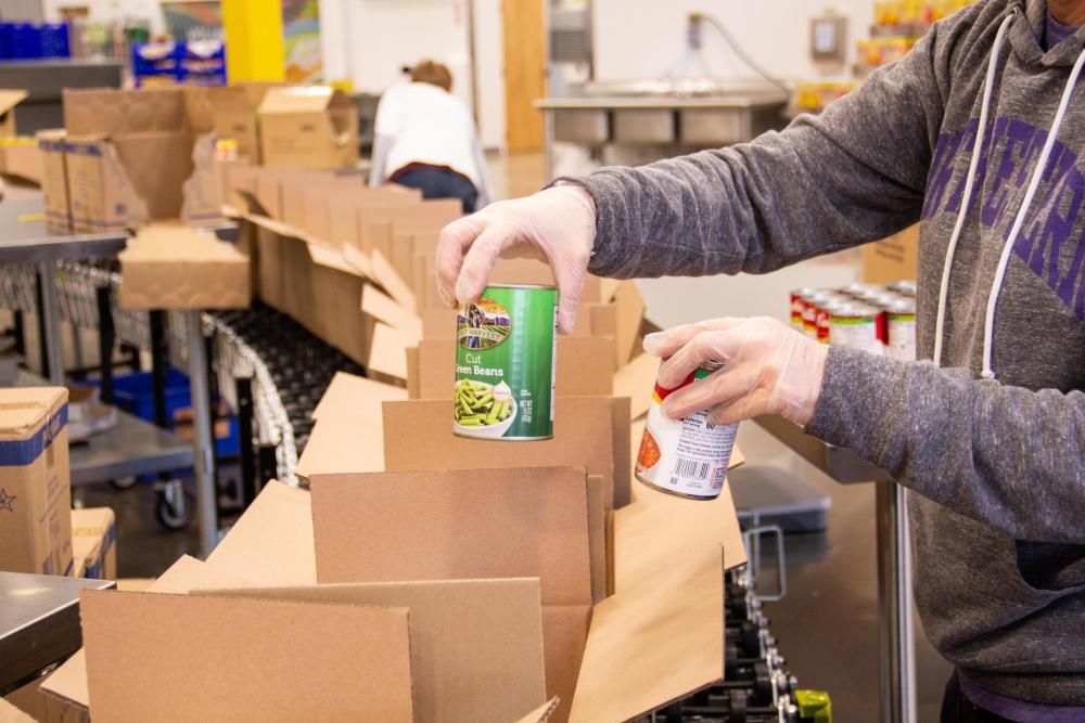 Canned goods being put in boxes on an assembly line