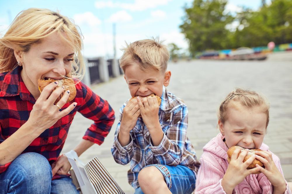 mom and kids eating burgers mom and kids eating burgers