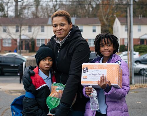 Family with Thanksgiving food box Family with Thanksgiving food box