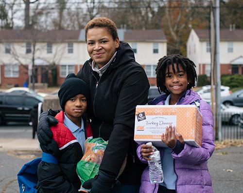 Family with Thanksgiving food box