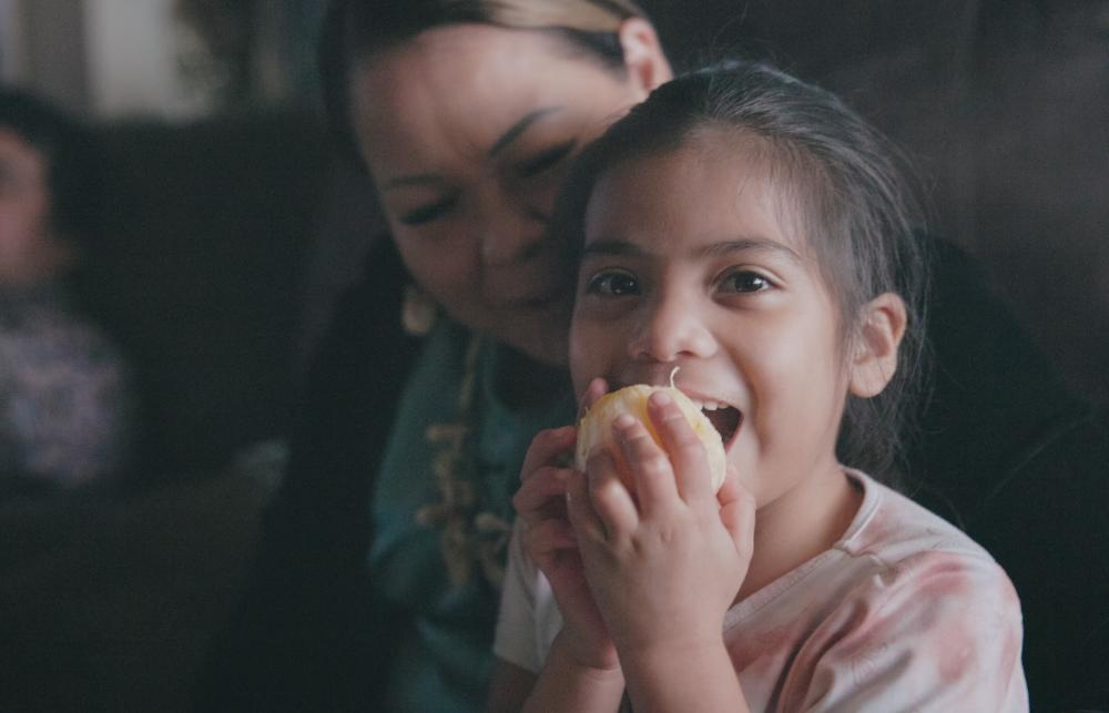 Girl eating orange